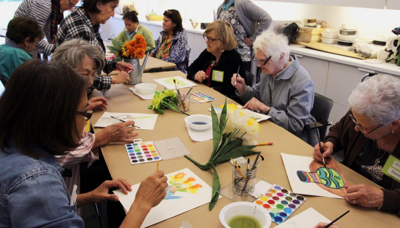 Group of elderly people painting with watercolors