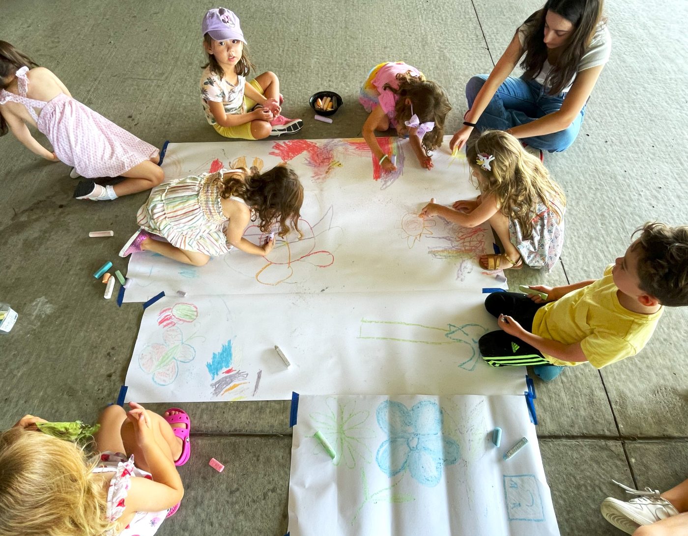 Group of children drawing with chalk